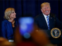 President Donald Trump, joined by Rep. Claudia Tenney, R-N.Y., speaks in Utica, N.Y., Monday, Aug. 13, 2018, at a joint fundraising committee reception in Utica, N.Y. (AP Photo/Carolyn Kaster)