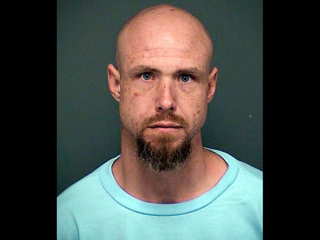 This undated booking photo released by the Tucson Police Department shows arrested man Dav