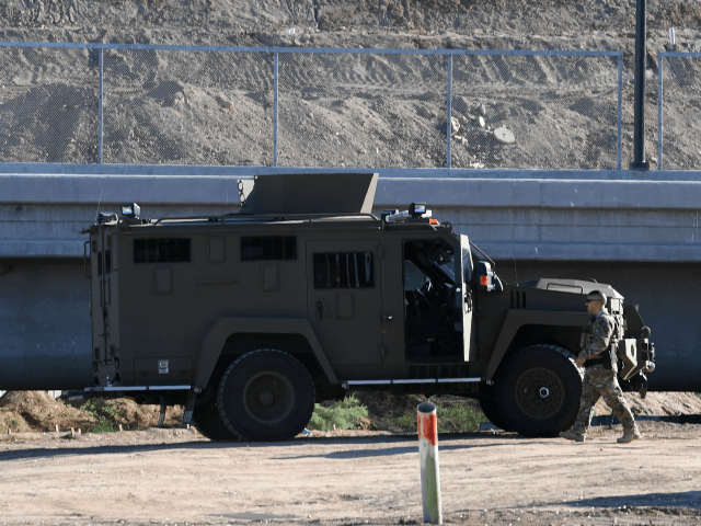 A military vehicle is parked beside the first completed section of the 30-foot border wall in the El Centro Sector, at the US-Mexico border in Calexico, California on October 26, 2018. (Photo by Mark RALSTON / AFP) (Photo credit should read MARK RALSTON/AFP/Getty Images)