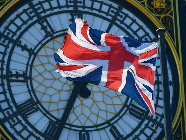 The Union Flag is seen in front of the clock face of Elizabeth Tower (Big Ben) at the Hous