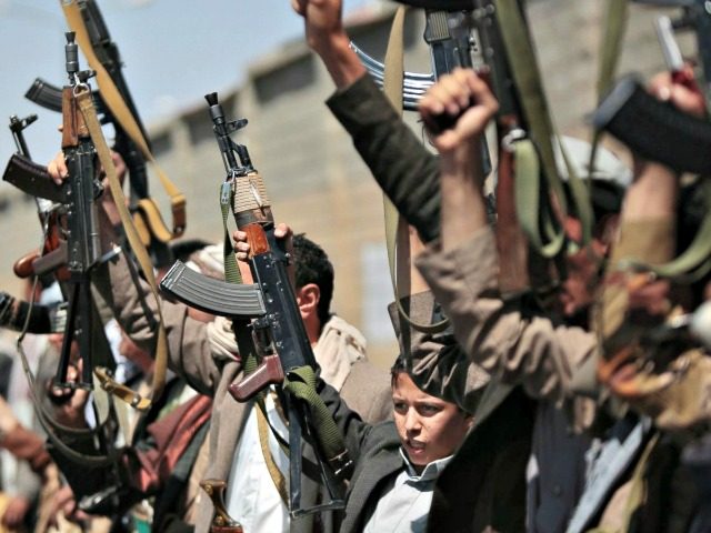 Houthi rebels hold their weapons aloft in Sana’a, Yemen.