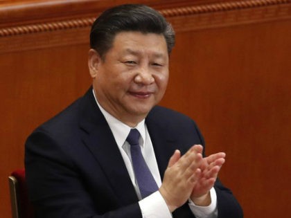 In this Sunday, March 11, 2018, photo, Chinese President Xi Jinping applauds after hearing the results of a vote on a constitutional amendment during a plenary session of China's National People's Congress (NPC) at the Great Hall of the People in Beijing. China’s move to scrap term limits and allow …
