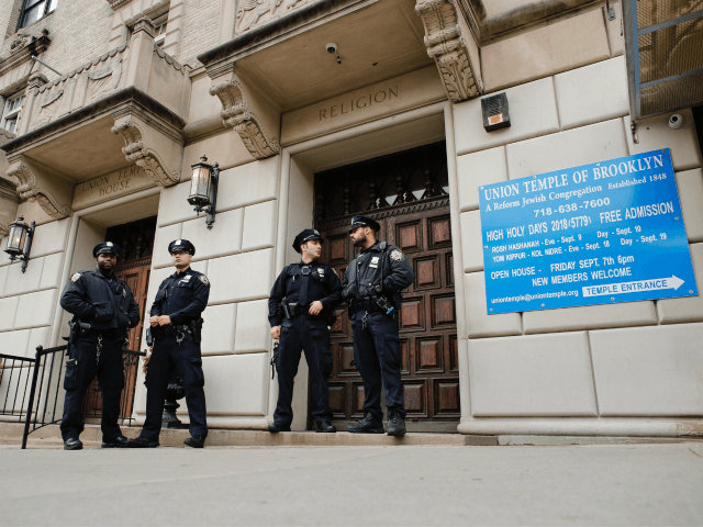 Synagogues NYPD officers stand guard at the door of the Union Temple of Brooklyn on November 2, 2018 in New York City. - New York police were investigating anti-Semitic graffiti found inside a Brooklyn synagogue that forced the cancellation of a political event less than a week after the worst …