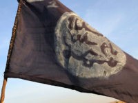 A Boko Haram flag flutters from an abandoned command post in Gamboru deserted after Chadian troops chased them from the border town on February 4, 2015. Nigerian Boko Haram fighters went on the rampage in the Cameroonian border town of Fotokol, massacring dozens of civilians and torching a mosque before …