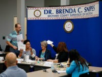 canvassing-board-Broward-County-getty Members of the canvassing board for the Broward County Supervisor of Elections Office review ballots on November 10, 2018 in Lauderhill, Florida. Three close midterm election races for governor, senator, and agriculture commissioner are expected to recounted in Florida. (Photo by Joe Skipper/Getty Images)