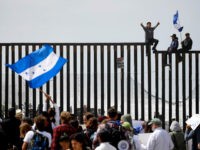 central-americans-climb-sit-border-wall-u-s-4-18-ap Central American migrants sit on top of the border wall on the beach in San Diego during a gathering of migrants living on both sides of the border, Sunday, April 29, 2018. (AP Photo/Chris Carlson)