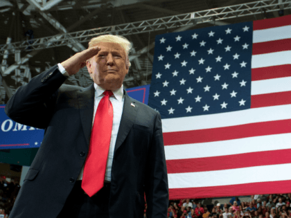 US President Donald Trump salutes as he arrives for a campaign rally in Estero, Florida, o