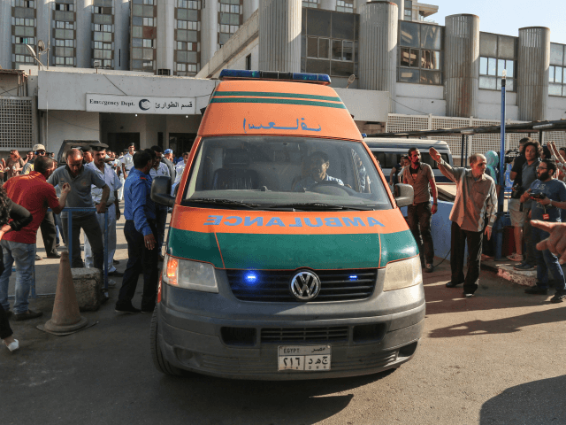 An ambulance transporting wounded Egyptians arrives at a hospital in Cairo's northern subu