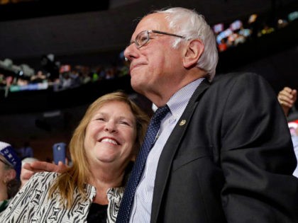 FILE- In this July 26, 2016 file photo, former Democratic presidential candidate, Sen. Bernie Sanders, I-Vt., hugs wife Jane during the second day of the Democratic National Convention in Philadelphia. A Republican lawyer pushing the allegations that Sen. Bernie Sanders’ wife committed bank fraud to win a loan while president …