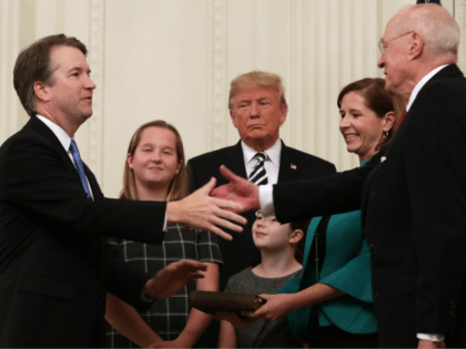 WASHINGTON, DC - OCTOBER 08: U.S. Supreme Court Associate Justice Brett Kavanaugh (L) shak