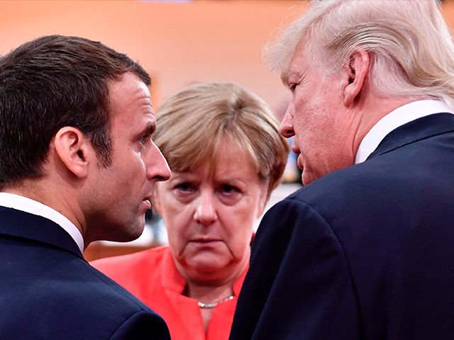 TOPSHOT - US President Donald Trump (R), French President Emmanuel Macron (L) and German Chancellor Angela Merkel (C) chat at the start of the first working session of the G20 meeting in Hamburg, northern Germany, on July 7, 2017. Leaders of the world's top economies will gather from July 7 …
