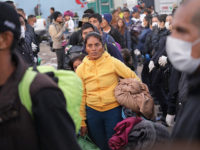 migrant-caravan-tijuana-mexico-nov-30-2018-getty TIJUANA, MEXICO - NOVEMBER 30: Police funnel members of the migrant caravan to a bus to be transported to a new temporary shelter on November 30, 2018 in Tijuana, Mexico. Authorities closed a squalid open-air shelter next to the U.S.-Mexico border fence and bussed thousands of migrants to a different …