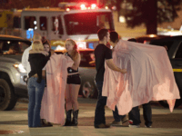 shooting in california People comfort each other as they sit near the scene Thursday, Nov. 8, 2018, in Thousand Oaks, Calif. where a gunman opened fire Wednesday inside a country dance bar crowded with hundreds of people on "college night," wounding 11 people including a deputy who rushed to the scene. Ventura County …