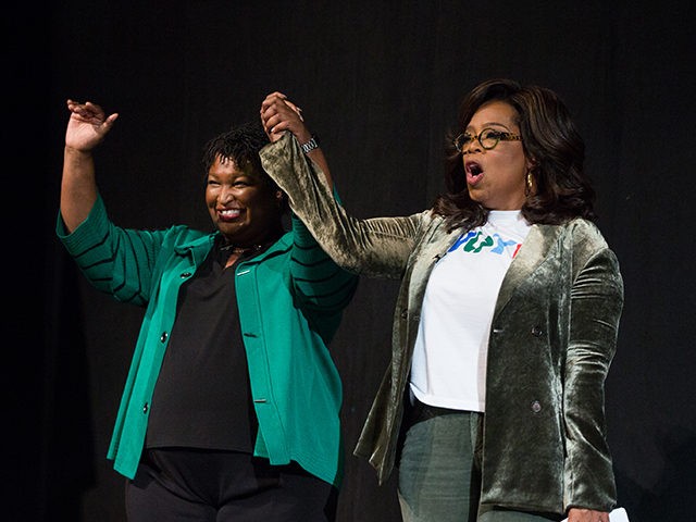 MARIETTA, GA - NOVEMBER 01: Oprah Winfrey and Georgia Democratic Gubernatorial candidate Stacey Abrams greet the audience during a town hall style event at the Cobb Civic Center on November 1, 2018 in Marietta, Georgia. Winfrey travelled to Georgia to campaign with Abrams ahead of the mid-term election. (Photo by …