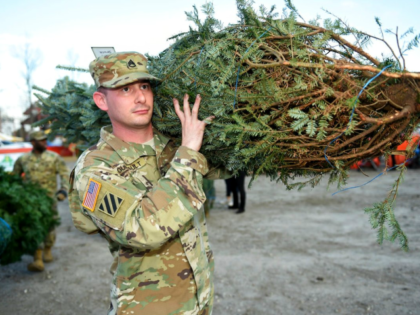 Staff Sgt. Nicholas Guilbault hauls away his Christmas tree during the annual Trees For Tr