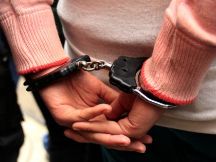 An unidentified female Colombian suspect in handcuffs is presented to the press after her Monday arrest in connection with seized cocaine at a police base in Lima, Peru, Wednesday Aug. 17, 2011. According to police, about one ton of cocaine was seized during two operations, on Aug. 11 and Aug. …