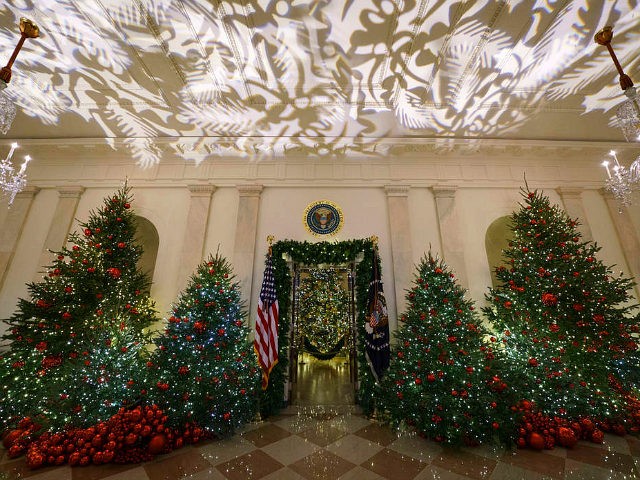 The Grand Foyer and Cross Hall leading into the Blue Room and the official White House Christmas tree are viewed during the 2018 Christmas preview at the White House in Washington, Monday, Nov. 26, 2018. (AP Photo/Carolyn Kaster)