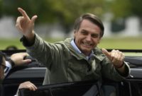 Jair Bolsonaro gives thumbs up to supporters after voting in the second round of the Brazil's presidential elections on October 28, 2018