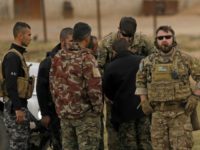 US forces and members of the Syrian Democratic Forces (SDF) patrol the Kurdish-held town of Al-Darbasiyah in northeastern Syria bordering Turkey