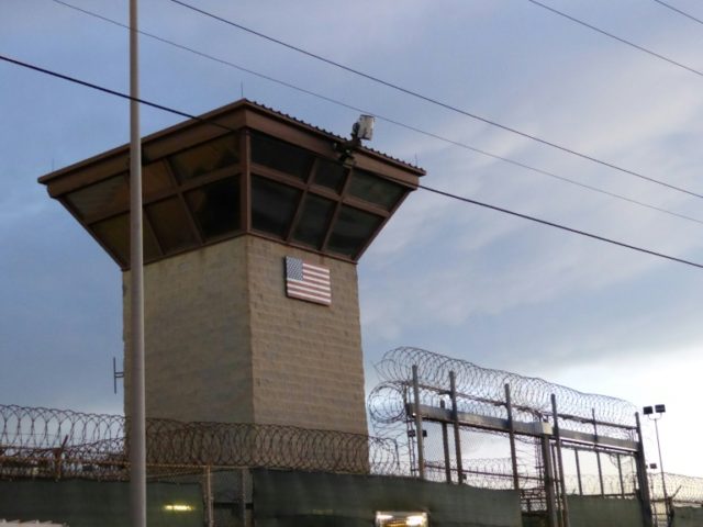 At Guantanamo, prisoners watch parade of US military guards go by