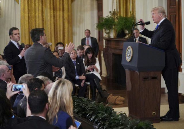 US President Donald Trump spars with CNN journalist Jim Acosta (C) and NBC's Peter Alexander (L), who came to Acosta's defense Trump clashes with 'rude, terrible' CNN reporter