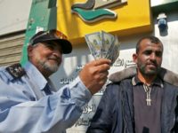 A Palestinian man shows his money after receiving his salary in Rafah in the southern Gaza Strip November 9, 2018 A Palestinian man shows his money after receiving his salary in Rafah in the southern Gaza Strip November 9, 2018