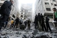Palestinians gather in front of damaged buildings in Gaza City early on November 13, 2018 following Israeli air strikes Palestinians gather in front of damaged buildings in Gaza City early on November 13, 2018 following Israeli air strikes