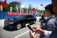 China's President Xi Jinping travels in a motorcade along the newly-dedicated Independence Drive Boulevard