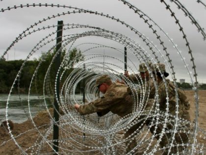 US Army unfurls miles of fencing along border with Mexico