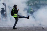 French police fired tear gas and water cannon against protestors in central Paris demanding President Emmanuel Macron French reverse motor feul tax hikes