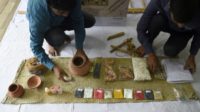 Workers at SarvaPooja''s manufacturing unit in Mumbai prepare a 'final rites kit', which includes a number of items including cow urine and dung, earthen pots and sesame seeds