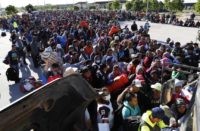 APTOPIX Central America Migrant Caravan Migrants traveling with a caravan hoping to reach the U.S. border, wait in line to board buses in La Concha, Mexico, Wednesday, Nov. 14, 2018. Buses and trucks are carrying some migrants into the state of Sinaloa along the Gulf of California and further northward into the border state of Sonora. The bulk of the main caravan appeared to be about 1,100 miles from the border, but was moving hundreds of miles per day. (AP Photo/Marco Ugarte) Migrant caravan groups arrive by hundreds at US border