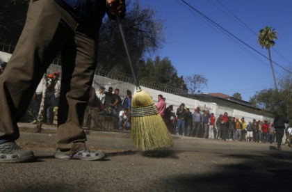 Central America Migrant Caravan Central American migrants sweep outside the shelter where they are staying in Tijuana, Mexico, Sunday, Nov. 18, 2018. Protesters accused the migrants of being messy, ungrateful and a danger to Tijuana; complained about how the caravan forced its way into Mexico, calling it an "invasion," and voiced worries that their taxes might be spent to care for the group as they wait possibly months to apply for U.S. asylum. (AP Photo/Marco Ugarte) Judge bars US from enforcing Trump asylum ban