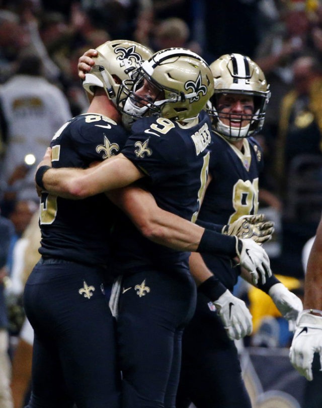 APTOPIX Falcons Saints Football New Orleans Saints quarterback Drew Brees (9) hugs tight end Dan Arnold (85) after the two connected on a touchdown reception in the second half of an NFL football game against the Atlanta Falcons in New Orleans, Thursday, Nov. 22, 2018. (AP Photo/Butch Dill) The Associated Press