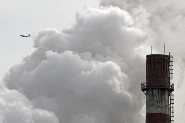 Climate Talks In this file photo taken Tuesday, Feb. 28, 2017, a passenger airliner flies past steam and white smoke emitted from China Huaneng Group's Beijing power plant that was the last coal fired plant to shut down on March 18, 2017 as the Chinese capital convert to clean energy like thermal power. (AP Photo/Andy Wong, File) The Associated Press