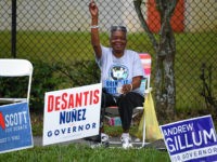 ORLANDO, FLORIDA - NOVEMBER 04: Campaigners hold placards outside an early voting station at West Kaley Street on November 4, 2018 in Orlando, Florida. U.S. Sen. Bill Nelson (D-FL), who was campaigning in the area, and outgoing Republican Florida Gov. Rick Scott are in a virtual dead heat just two …
