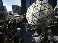 2019-new-years-eve-ball-drop-times-square-1218-AP Media watch as workmen demonstrate the replacement of a panel on the New Year's Eve ball on top of a building in Times Square, New York, Thursday, Dec. 27, 2018. Preparations for New Year's Eve in Times Square are taking shape, and some of those shapes are 192 new crystal …