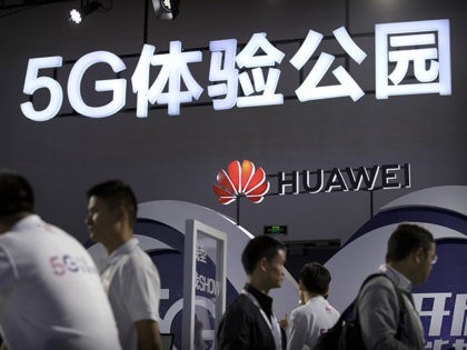 Visitors look at a display for 5G wireless technology from Chinese technology firm Huawei