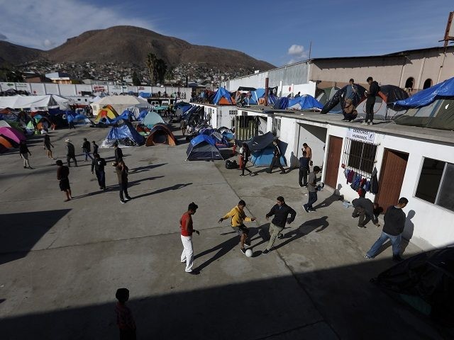 Migrants play soccer at a former concert venue serving as a shelter for migrants in Tijuan