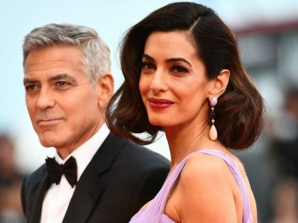 VENICE, ITALY - SEPTEMBER 02: George Clooney and Amal Clooney walk the red carpet ahead of