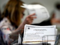 Ballots are recounted in Maine's 2nd Congressional District, Thursday, Dec. 6, 2018, in Augusta, Maine. The recount was requested by outgoing U.S. Rep. Bruce Poliquin after losing a November ranked-choice race to Rep.-elect Jared Golden. (AP Photo/Robert F. Bukaty)