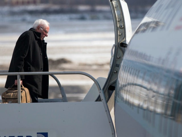 Democratic presidential candidate, Sen. Bernie Sanders, I-Vt. boards his campaign plane in Milwaukee, Friday, Feb. 12, 2016, en route to Minneapolis. (AP Photo/Evan Vucci)