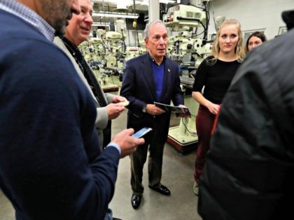 Former New York City Mayor Michael Bloomberg, center, talks with students in the Wind Technology program at Des Moines Area Community College, Tuesday, Dec. 4, 2018, in Ankeny, Iowa.