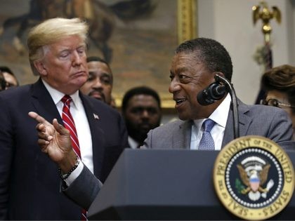 Bob Johnson, founder of BET, right, gestures as he speaks next to President Donald Trump during a ceremony for the signing of an executive order establishing the White House Opportunity and Revitalization Council, in the Roosevelt Room of the White House, Wednesday, Dec. 12, 2018, in Washington. (AP Photo/Jacquelyn Martin)