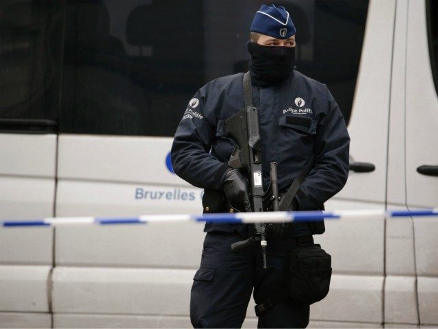 An armed Belgian police officer stands guard near Maelbeek - Maalbeek subway station in Brussels on March 23, 2016, a day after triple bomb attacks in the Belgian capital killed about 35 people and left more than 200 people wounded. A series of explosions claimed by the Islamic State group …