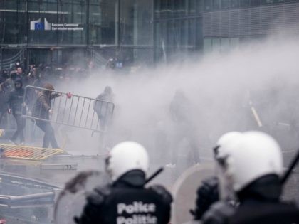 Protestors face off against the police during an anti-migrant demonstration outside of EU