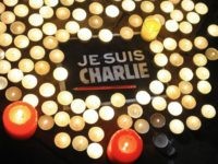Charlie Hebdo Candles are placed next to a sign reading 'Je suis Charlie' (I am Charlie) and a pen in La Rochelle on January 7, 2015, as people gathered to pay tribute to the twelve people killed in an attack by two armed gunmen on the offices of French satirical newspaper Charlie …