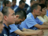 Inmates attend a ceremony to mark Mother's Day with some of their mothers at Chongqing Prison May 8, 2005 in Chongqing Municipality, China. The prison has invited mothers of inmates to celebrate Mother's Day during an event at the facility. China has carried out prison reform in big cities like …