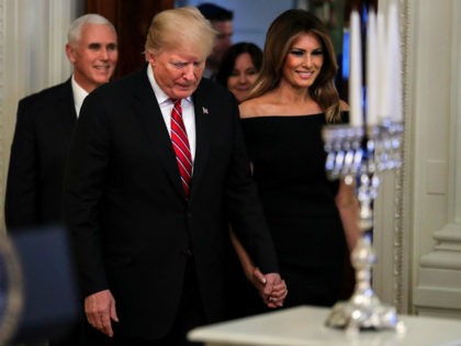 WASHINGTON, DC - DECEMBER 6: (AFP-OUT) President Donald Trump and first lady Melania Trump attend a Hanukkah reception in the East Room of the White House on December 6, 2018 in Washington, DC. (Photo by Oliver Contreras-Pool/Getty Images)