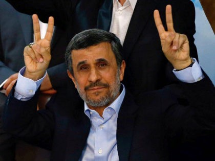 Former Iranian president Mahmoud Ahmadinejad (C) flashes the sign for victory at the Interior Ministry's election headquarters as candidates begin to sign up for the upcoming presidential elections in Tehran on April 12, 2017. Ahmadinejad had previously said he would not stand after being advised not to by supreme leader …